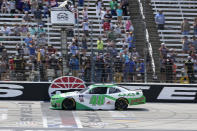 Tyler Reddick (48) takes the checkered flag to win the NASCAR Xfinity Series auto race at Texas Motor Speedway in Fort Worth, Texas, Saturday, May 21, 2022. (AP Photo/Larry Papke)