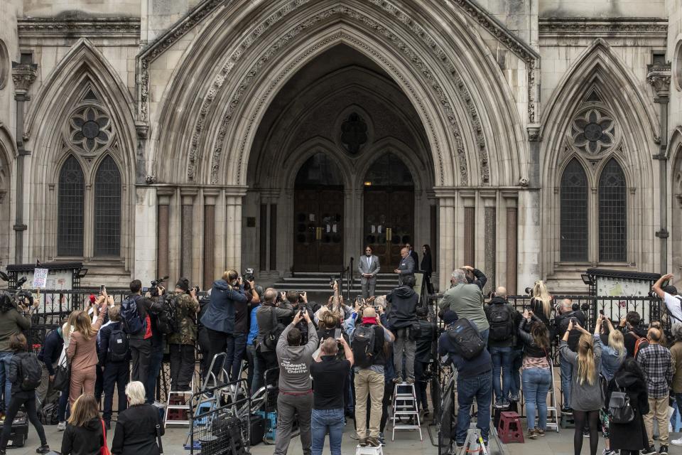 A crowd of fans and media photographers greet Johnny Depp as he arrives for court in London on July 16, 2020.