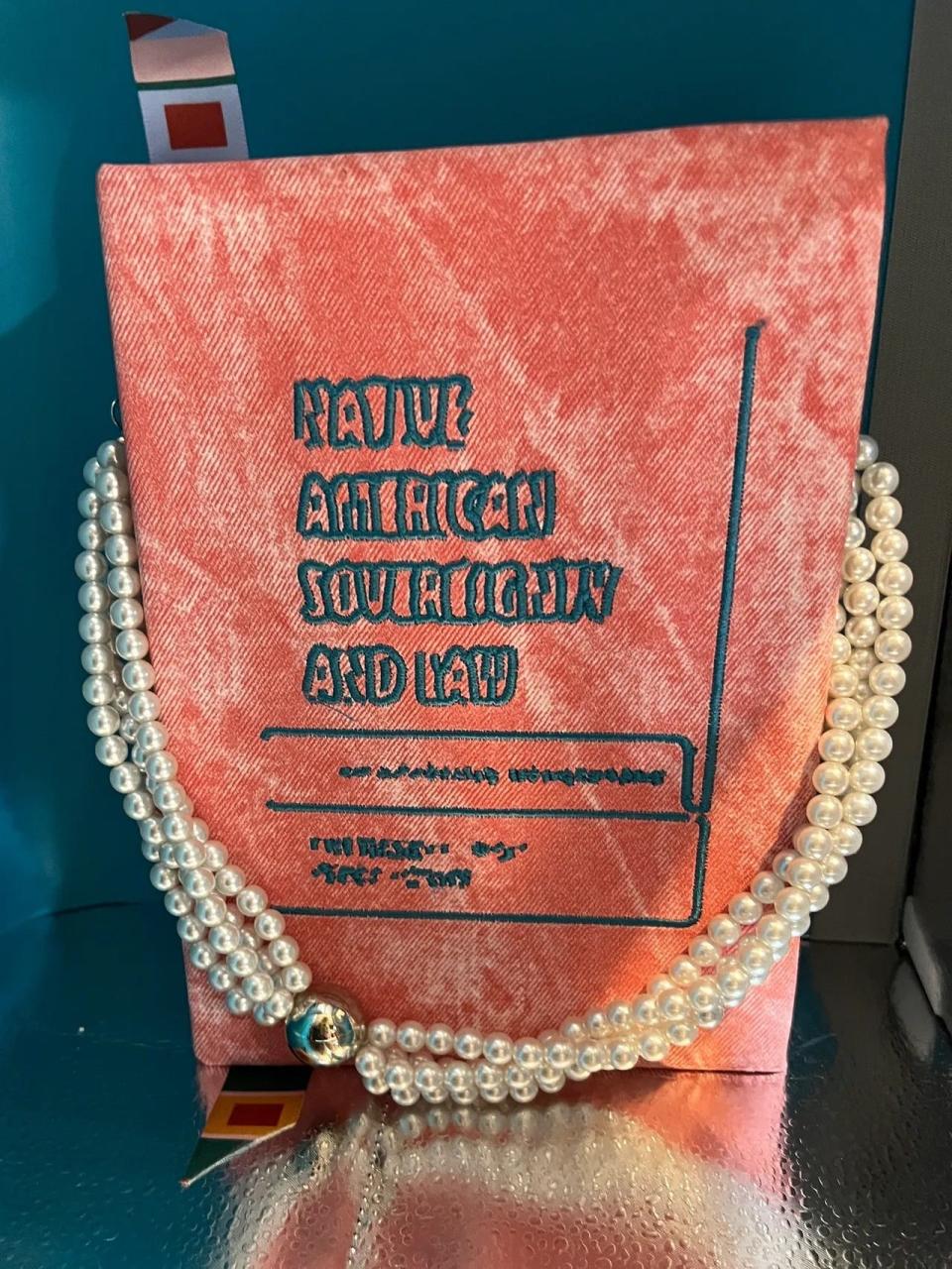 For their 2024 New York Fashion Week show, Claremore-based Muscogee fashion designer Lea McCormick created a handbag modeled on a Native American law book to go with a "Legally Blonde"-inspired dress devised by Owasso clothing designer Kelsey Cooper, who is Cherokee.