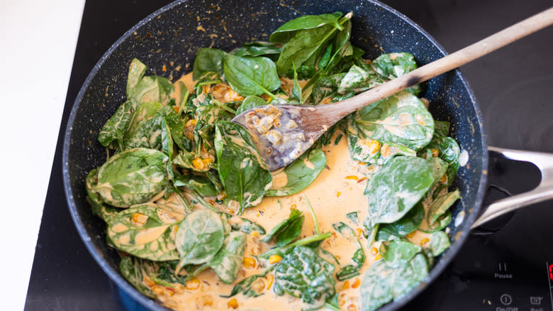 spinach and sauce in pan
