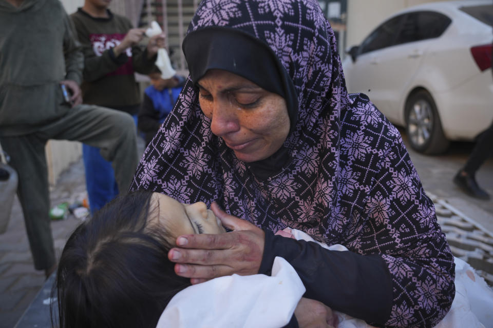 A mother cries for her daughter who was killed in the Israeli bombardment of the Gaza Strip al in Deir al Balah on Saturday, Dec. 2, 2023. (AP Photo/ Hatem Moussa)