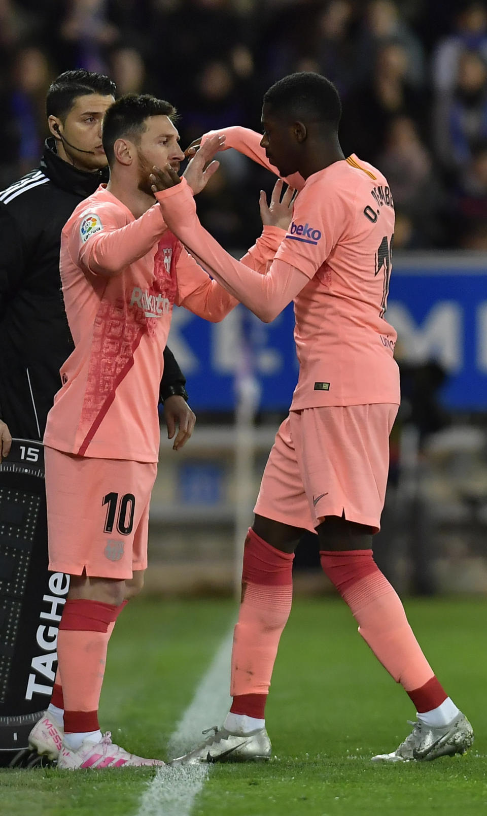 Barcelona forward Ousmane Dembele is replaced by forward Lionel Messi during a Spanish La Liga soccer match between Deportivo Alaves and FC Barcelona at the Medizorrosa stadium in Vitoria, Spain, Tuesday, April 23, 2019. (AP Photo/Alvaro Barrientos)
