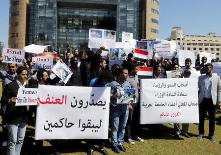 Lebanese and Arab students carry signs and Yemeni national flags during a protest against Saudi-led air strikes on Yemen, in front of the offices of the U.N. headquarters in Beirut April 1, 2015. REUTERS/Mohamed Azakir