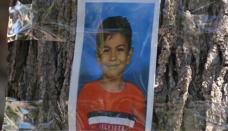 A third grade student’s photo is taped to a tree after he was killed in a crosswalk by Castlemont Elementary School in 2022. (KRON4 photo)