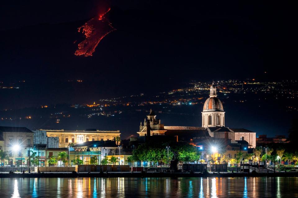 Lava flowing along the sides of the southern crater of the Etna volcano