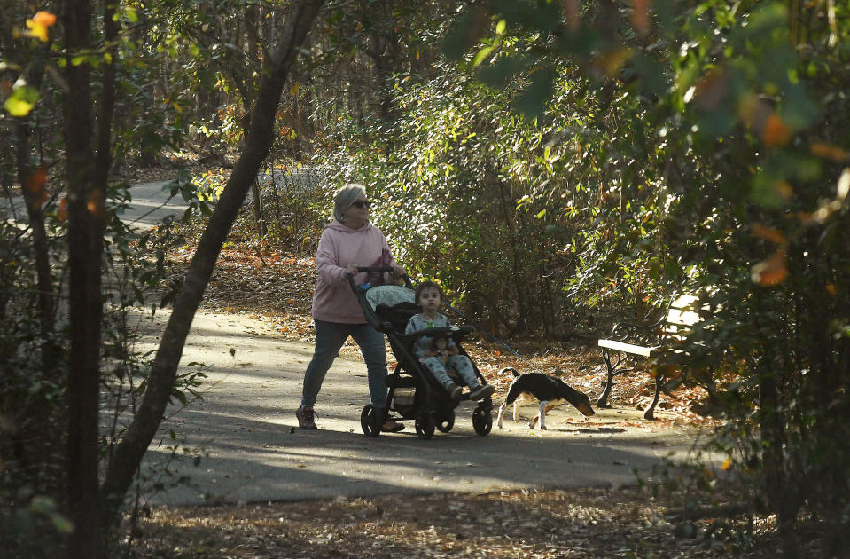 People walk around the Gary Shell Cross City Trail at Halyburton Park.