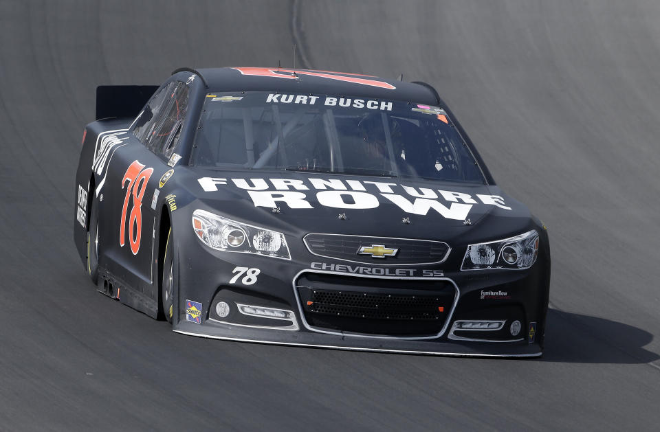 FILE - In this Aug. 18, 2013, file photo, Kurt Busch races during the NASCAR Sprint Cup series Pure Michigan 400 auto race at Michigan International Speedway in Brooklyn, Mich. Kurt Busch and Andretti Autosport announced Tuesday, March 4, 2014, that he will try to become the first driver in 10 years to run the Indianapolis 500 and the Coca-Cola 600 on the same day. (AP Photo/Paul Sancya, File)