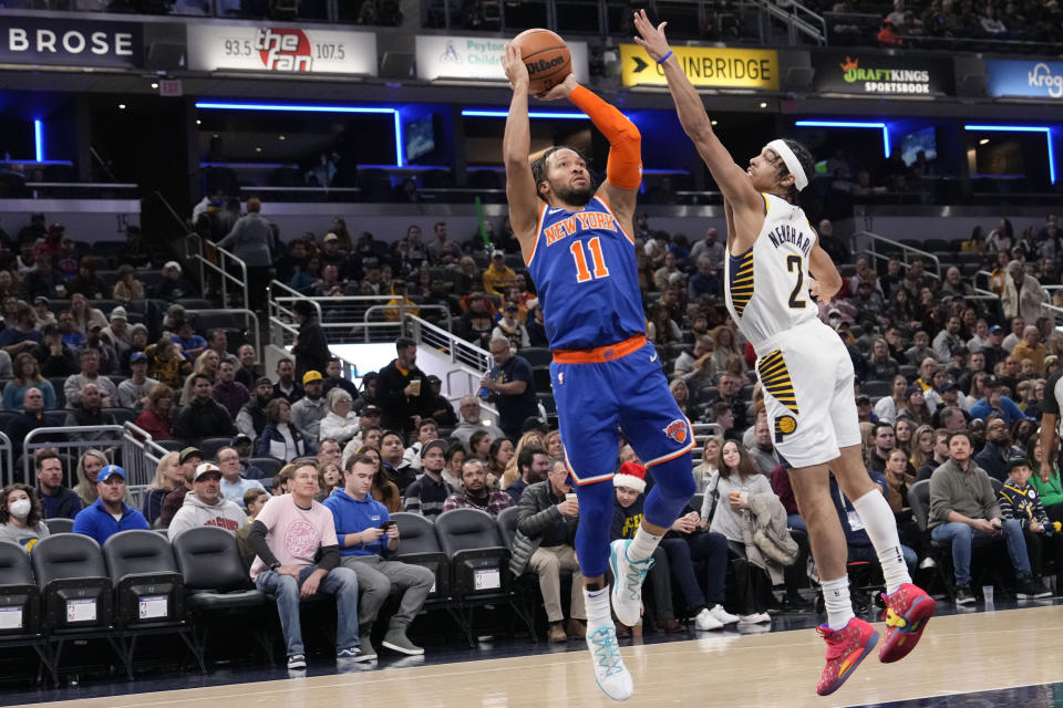New York Knicks guard Jalen Brunson (11) shoots over Indiana Pacers guard Andrew Nembhard (2) during the first half of an NBA basketball game in Indianapolis, Sunday, Dec. 18, 2022. (AP Photo/AJ Mast)