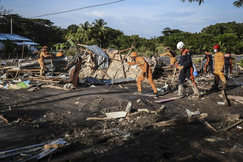 Rescuers search for missing bodies in a mudslide after Tropical Storm Nalgae hit Barangay Kusiong, Datu Odin Sinsuat, Maguindanao province, southern Philippines on Monday Oct. 31, 2022. Philippine officials say more than 100 people have died in one of the most destructive storms to lash the Philippines this year. (AP Photo)