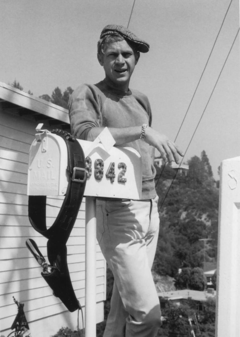 <div class="inline-image__caption"><p><b>Casual 1960</b> – A rare and relaxed photo of Steve McQueen standing in front of his home mailbox on 8842 Skyline Drive in Laurel Canyon, Los Angeles. The 883-square-foot home was built in 1952.</p></div> <div class="inline-image__credit">MPLA</div>