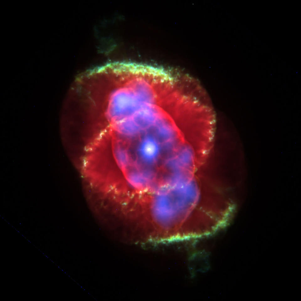 The interior of a planetary nebula glows in radient colors January 9, 2001 in an image taken by NASA's Chandra X-ray Observatory. Astronomers unexpectedly found a central star in the late stages of life emitting powerful X-ray energy. The X-ray observations of the Cat's Eye Nebula reveal a hot gas cloud around a bright star, which is shedding its material and is expected to collapse into a white dwarf in several million years. (Photo courtesy of NASA/Newsmakers)