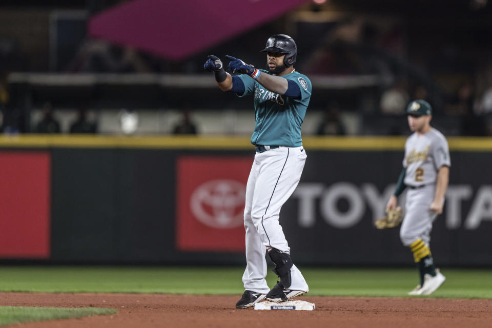 Seattle Mariners' Carlos Santana reacts after hitting a double off Oakland Athletics starting pitcher Ken Waldichuk during the fourth inning of a baseball game Friday, Sept. 30, 2022, in Seattle. (AP Photo/Stephen Brashear)