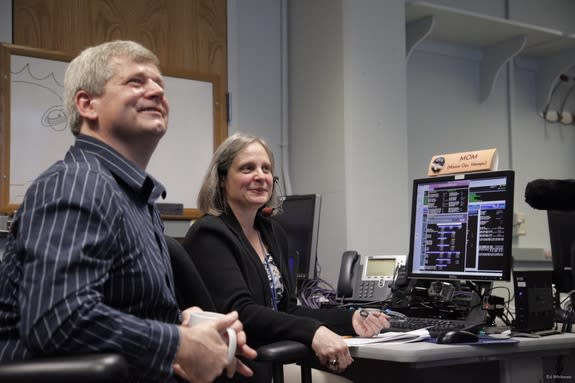 NASA's New Horizon Pluto flyby mission operations manager Alice Bowman and operations team Karl Whittenburg watch screens for signals confirming that the New Horizons probe awoke from hibernation on Dec. 6, 2014. The New Horizons mission is man