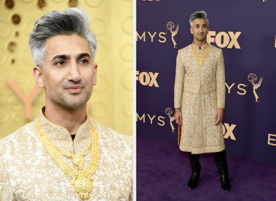 Person on red carpet in embroidered sherwani with matching boots and multiple necklaces