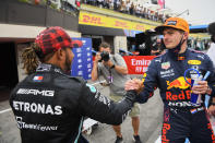 Red Bull driver Max Verstappen of the Netherlands, right, shakes hands with Mercedes driver Lewis Hamilton of Britain after he clocked the fastest time during the qualifying session ahead of the French Formula One Grand Prix at the Paul Ricard racetrack in Le Castellet, southern France, Saturday, June 19, 2021. The French Grand Prix will be held on Sunday. (Nicolas Tucat/Pool via AP)