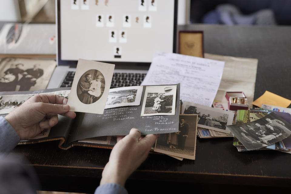 Someone looking at old family photos and documents