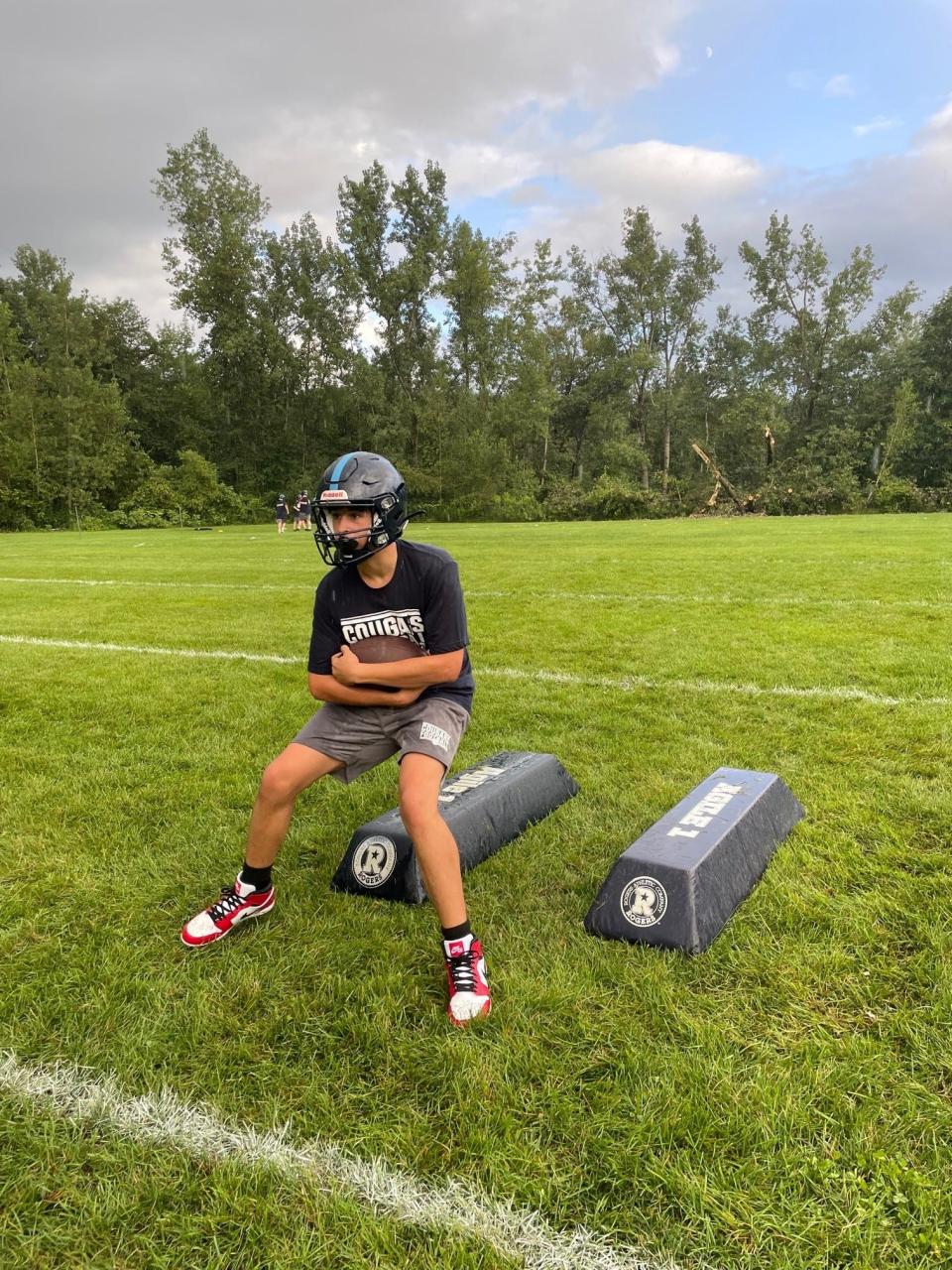 A Mount Mansfield running back runs a drill.