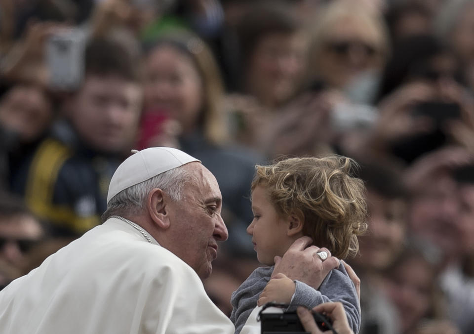 Pope Francis kisse a child as as he tours St. Peter's Square at the Vatican, upon his arrival for a general audience, Wednesday, Feb. 19, 2014. (AP Photo/Alessandra Tarantino)