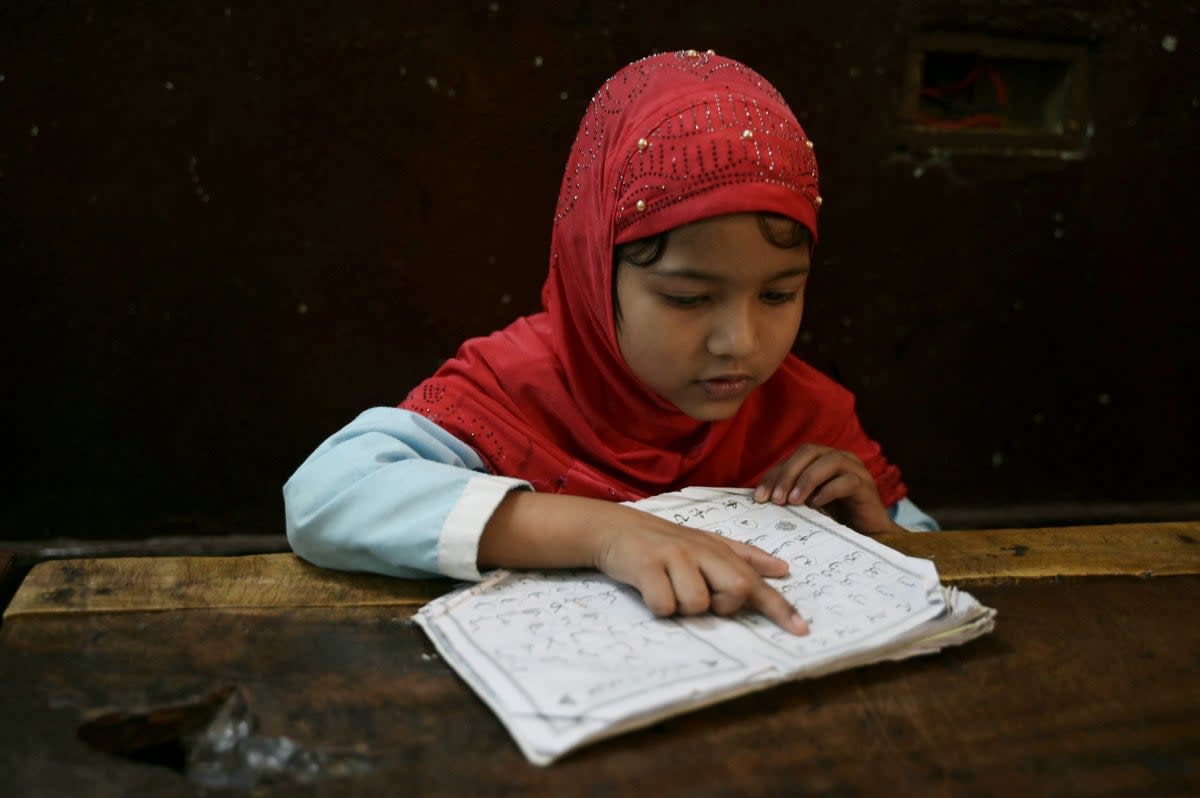 A student recites the Holy Quran in a classroom during the Islamic holy month of Ramadan at the Madrasatur-Rashaad religious school in Hyderabad  (AFP via Getty Images)