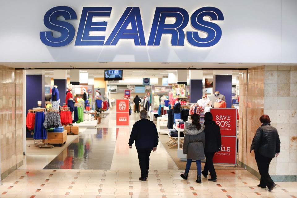 Shoppers enter the Sears department store at the Tri-County Mall, Wednesday, March 22, 2017, in Springdale, Ohio. Sears, once the monolith of American retail, says that there is "substantial doubt" that it will be able to keep its doors open. (AP Photo/John Minchillo)