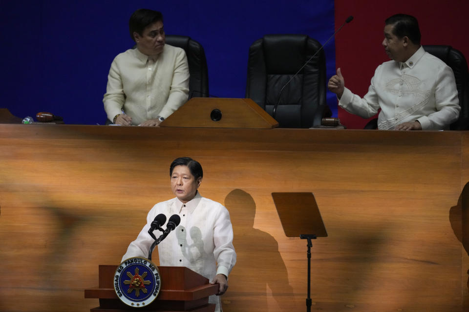 Philippine President Ferdinand Marcos Jr., center, delivers his state of the nation address while Senate president Juan Miguel Zubiri, left, and House speaker Martin Romualdez talks at the House of Representatives in Quezon City, Philippines on Monday, July 24, 2023. (AP Photo/Aaron Favila)