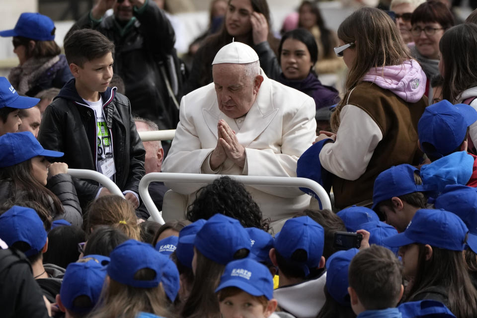 Pope Francis meets children at the end of his weekly general audience in St. Peter's Square, at the Vatican, Wednesday, March 29, 2023. (AP Photo/Alessandra Tarantino)