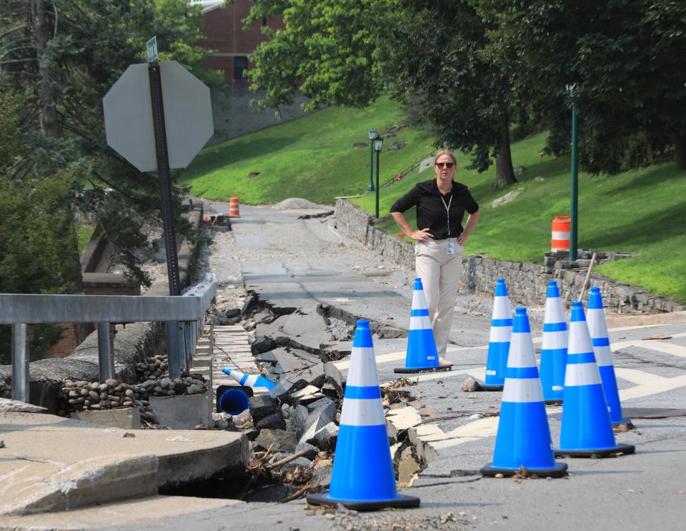 West Point public relations staff Cheryl Boujaida looks over a damaged road on July 17, 2023. A severe rain storm on July 9 caused an estimated $100 million in damages around West Point.