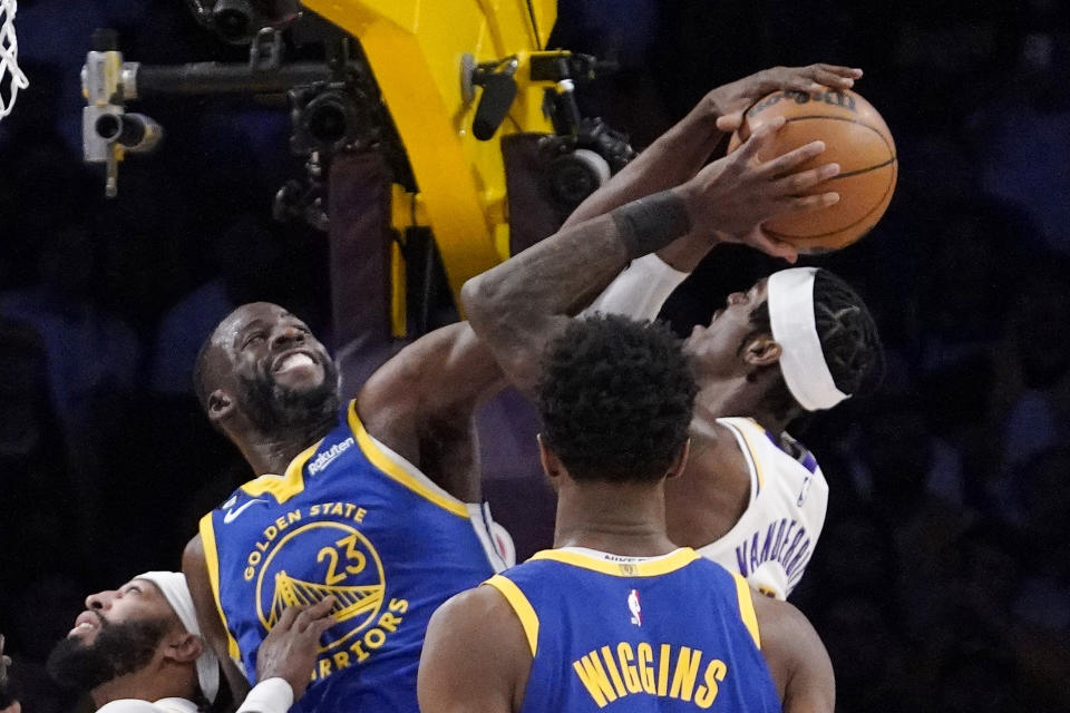 Golden State Warriors forward Draymond Green, left, rejects a shot by Los Angeles Lakers forward Jarred Vanderbilt, right, during the first half in Game 3 of an NBA basketball Western Conference semifinal Saturday, May 6, 2023, in Los Angeles. (AP Photo/Mark J. Terrill)