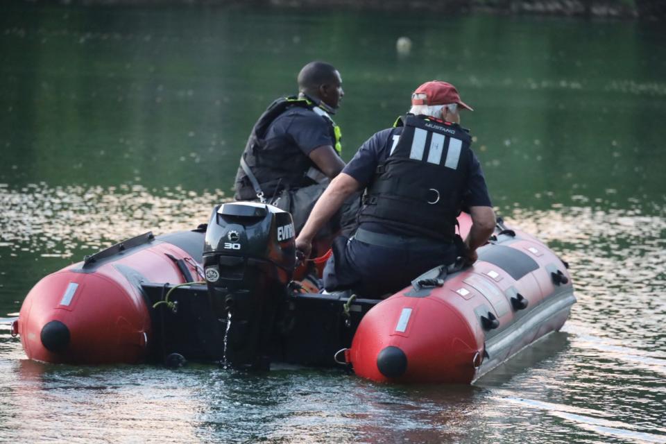 Search and rescue crews worked Tuesday to recover a vehicle from a pond on Bluff Road in Indianapolis.  (Indianapolis Fire Department / Twitter)