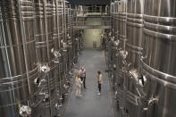 Winemakers taste rose in the production facility of the Chateau Sainte Roseline in the southern France region of Provence Friday Oct. 11, 2019. European producers of premium specialty agricultural products like French wine, Italian Parmesan and Spanish olives are facing Friday’s U.S. tariff hike with a mix of trepidation and indignation at being dragged into a trade war over the fiercely competitive aerospace industry.(AP Photo/Daniel Cole)