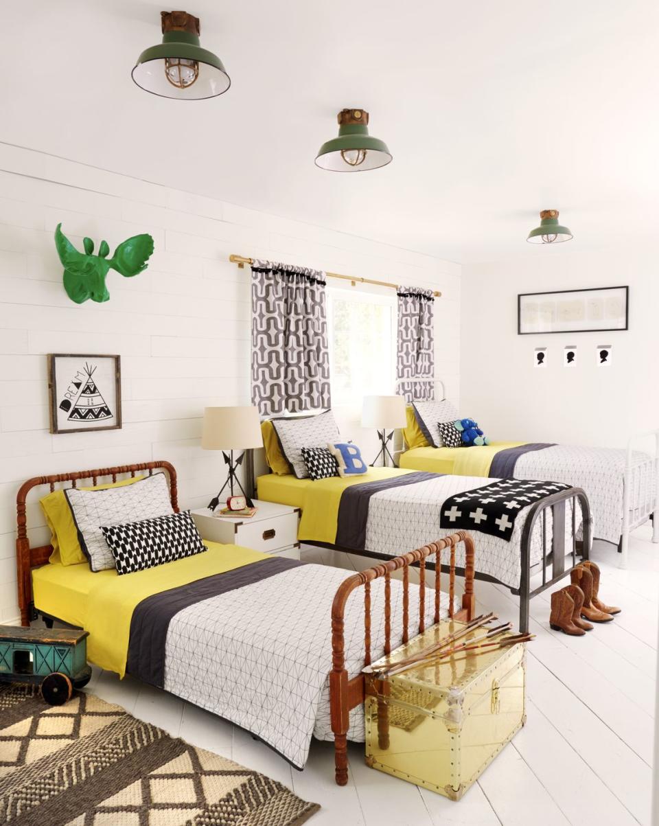 farmhouse kids room with three twin beds with yellow sheets