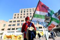 Protester holds a flag during a demonstration outside of the Shell headquarters, in The Hague