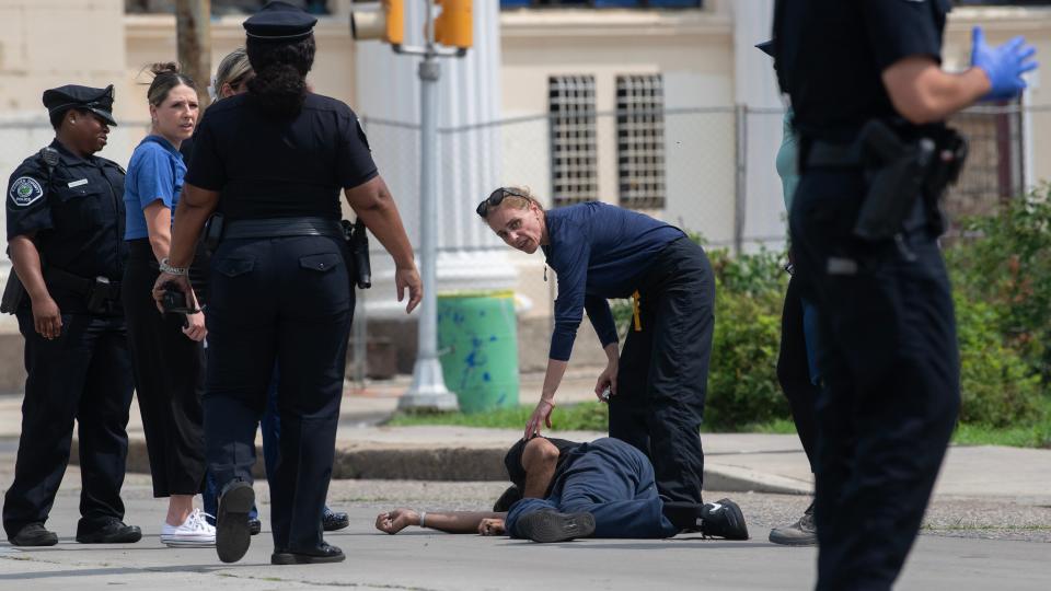 Healthcare workers and first responders participating in a Camden County outreach program render aid to a man who collapsed in the middle of a nearby busy Camden intersection on July 20, 2023.