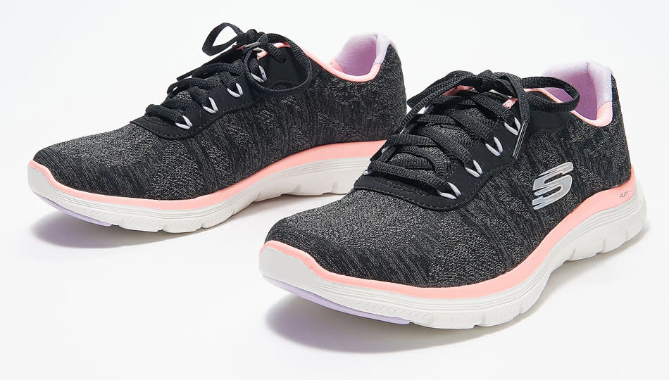 black Sketchers sneakers with white sole and pink band