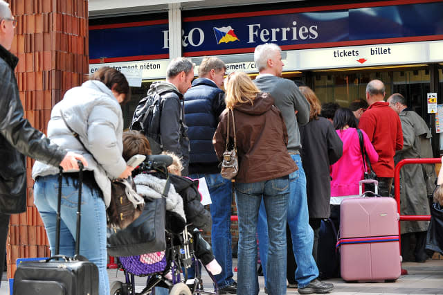 Travellers queue to buy ferry tickets to