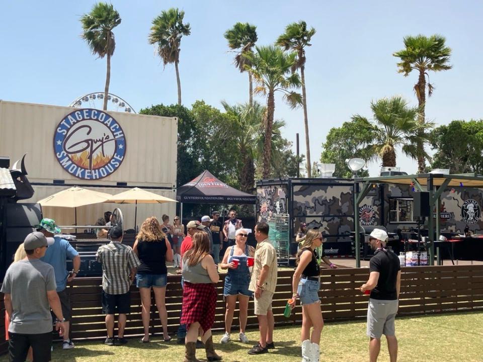 Barbecue fans mill around Guy Fieri's Smokehouse in it's new location during Stagecoach 2024 right next to the craft beer area.