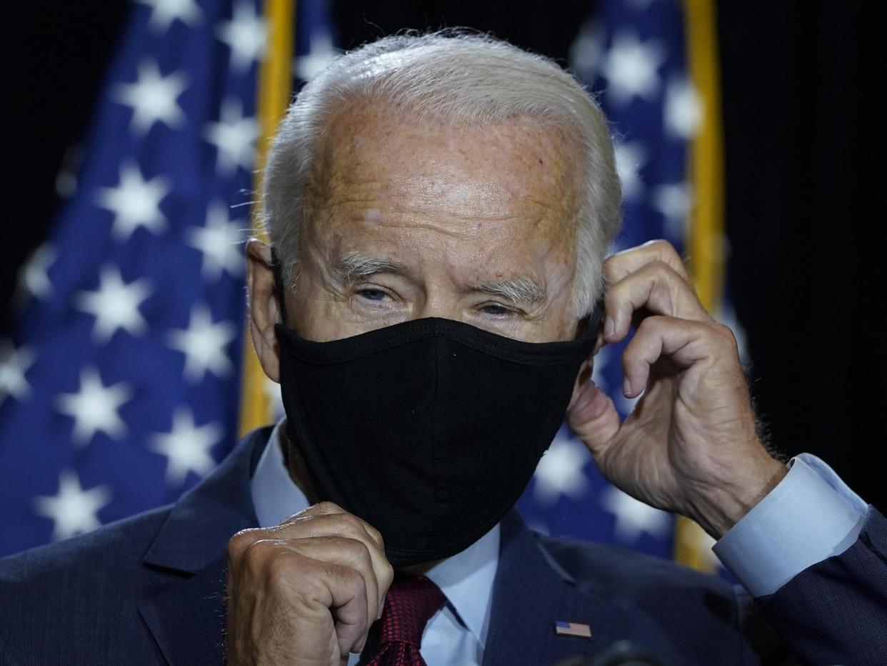 Presumptive Democratic presidential nominee former vice president Joe Biden puts his mask back on after delivering remarks following a coronavirus briefing with health experts at the Hotel DuPont on 13 August 2020 in Wilmington, Delaware: (2020 Getty Images)