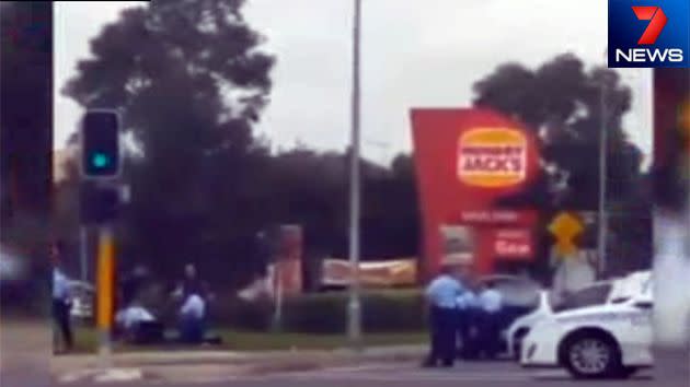 Officers outside the West Hoxton Hungry Jack's where the young woman was shot after allegedly lunging at police with a knife. Photo: 7News