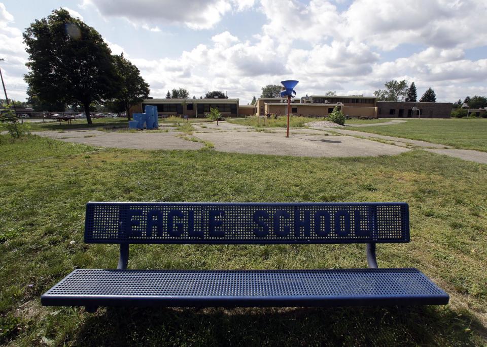 A bench is shown outside the former Eagle Elementary School in West Bloomfield, Mich., Wednesday, Aug. 29, 2012. This affluent Detroit suburb with a diverse mix of religions and races and center of the region's Jewish community is the latest battleground over mosque construction, as some residents push back against a school district's decision to sell a vacant elementary school to an Islamic group. The Farmington Hills school district defends its agreement to sell Eagle Elementary School to a Muslim association and an administrator says opposition now can be classified as "Islamophobia." (AP Photo/Paul Sancya)