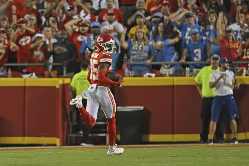 Chiefs corner Jaylen Watson (35) looks back as he returns an interception for a score against the Chargers in Week 2.