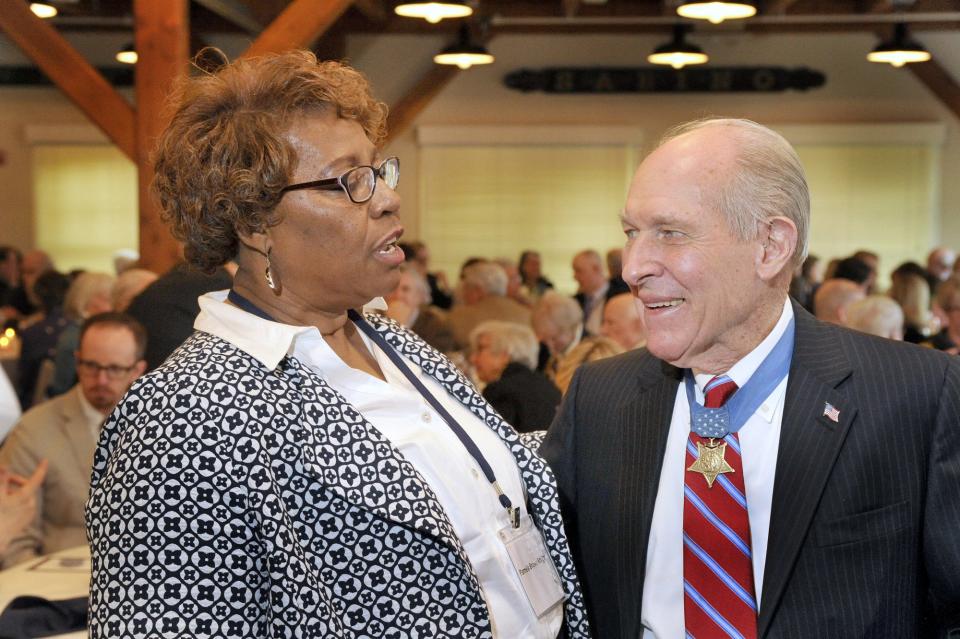 Friday, April 12, 2013 -- Captain Thomas J. Hudner, a Medal of Honor recipient, was honored at a celebration at the Maine Maritime Museum for becoming the namesake of the USS Thomas Hudner (DDG 116) which will be built at BIW. Captain Hudner, who received his Medal of Honor for his efforts to rescue fellow pilot Jessie Brown during the Korean conflict, speaks with Browm's daughter, Pamela Brown Knight at the luncheon celebration.  (Photo by John Ewing/Portland Press Herald via Getty Images)