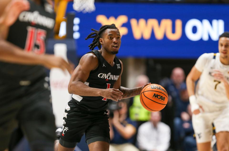 Jan 31, 2024; Morgantown, West Virginia, USA; Cincinnati Bearcats forward Kalu Ezikpe (1) dribbles the ball during the first half against the West Virginia Mountaineers at WVU Coliseum.