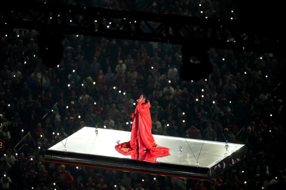 Phone torches lit up in the stands while Rihanna was winched into the sky (AP)