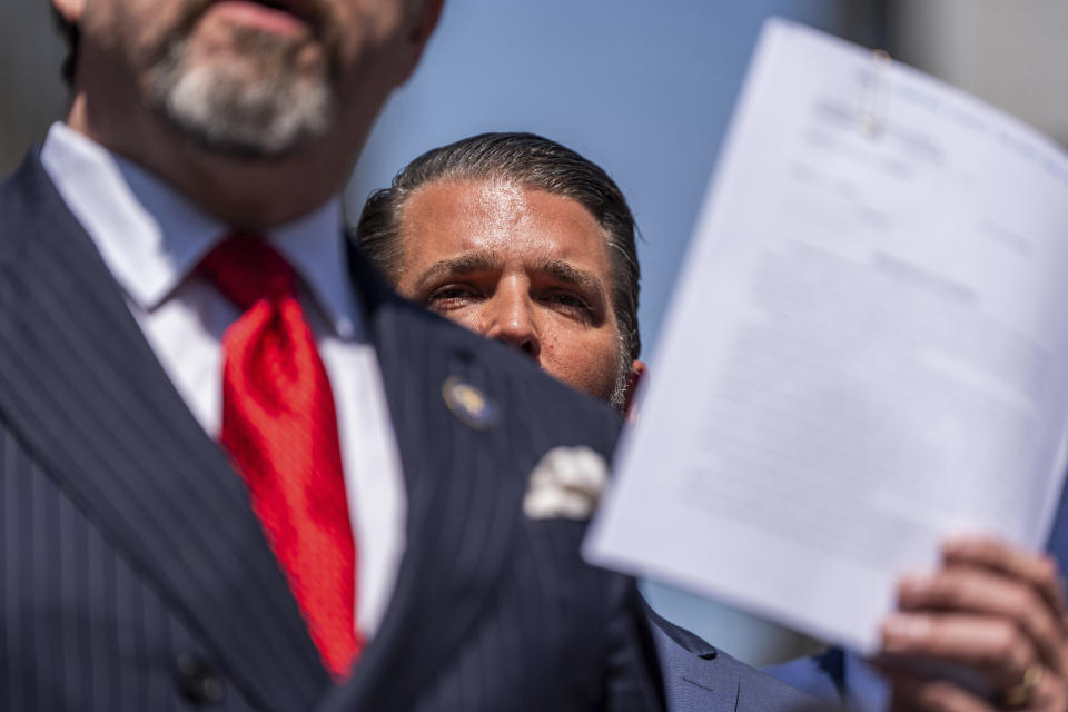 CORRECTS LAST NAME TO GORKA, NOT GORDA - Donald Trump Jr. looks on as Sebastian Gorka speaks during a press conference outside Manhattan criminal court, Tuesday, May 21, 2024, in New York. (AP Photo/Julia Nikhinson)