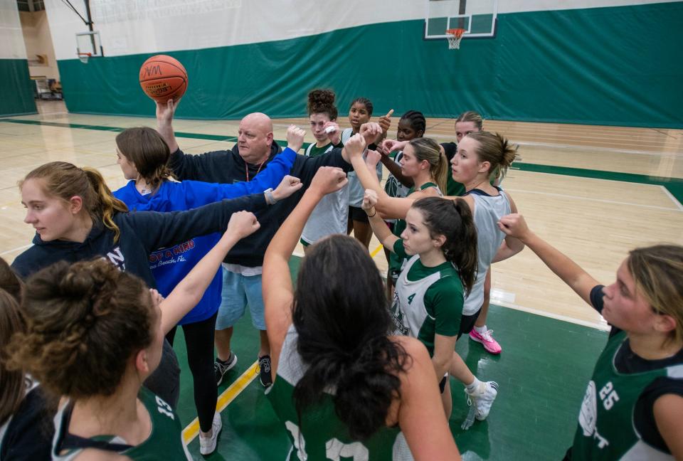 Wachusett Regional girls' basketball coach Jim Oxford gathers his players during practice Monday, December 4, 2023.