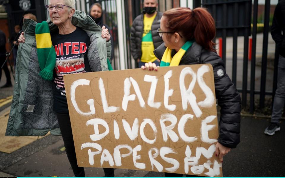 Protesters holding a placard reading 'Glazers Divorce Papers In Post' stand outside Old Trafford Stadium ahead of the Premier League match between Manchester United and Liverpoo - Getty Images