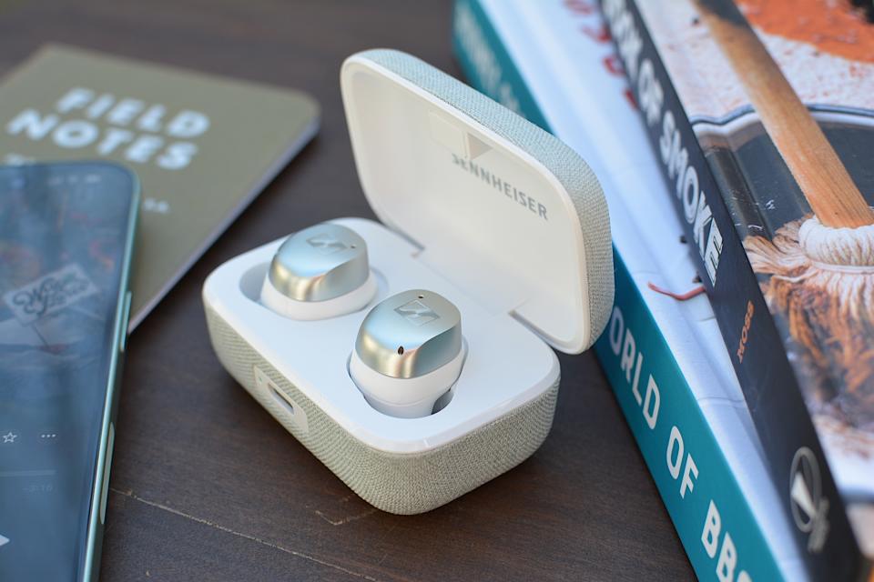 <p>White/silver Sennheiser Momentum True Wireless 4 earbuds sitting in their case with the lid open, photo taken from the front right corner.</p>
