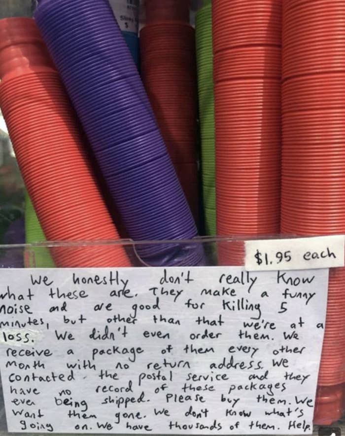 A long, handwritten note begging customers to buy these $2 thin, round, multicolored items that the store can't identify (but may be noise-makers) and doesn't know who orders them, but they keep coming every other month