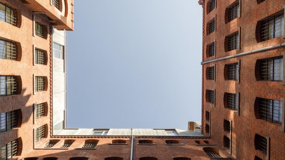 Upward view of the square brick building in the Wilmina Hotel that used to be the prison cell block.