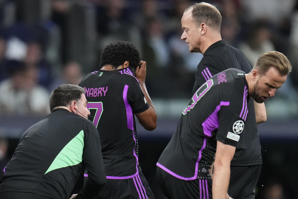 Bayern's Serge Gnabry, second left, gestures as he leaves the pitch after being injured during the Champions League semifinal second leg soccer match between Real Madrid and Bayern Munich at the Santiago Bernabeu stadium in Madrid, Spain, Wednesday, May 8, 2024. (AP Photo/Manu Fernandez)